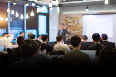 business meeting with presenter in front of audience engaging six professional participants